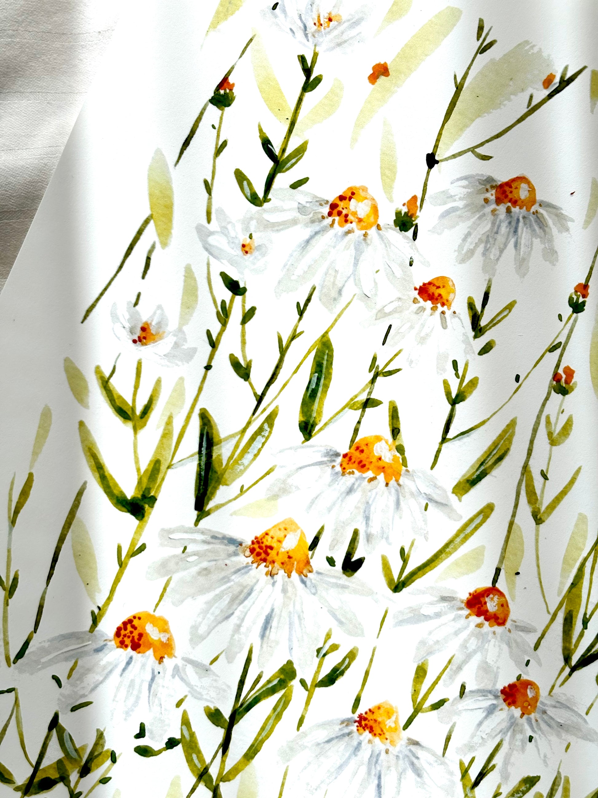 bright photo of an art print of daisies