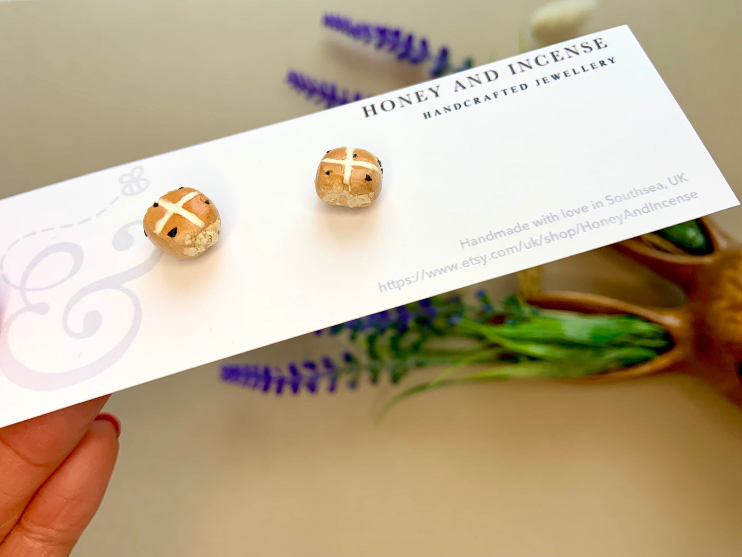 a pair of mini hot cross bun earrings realistic