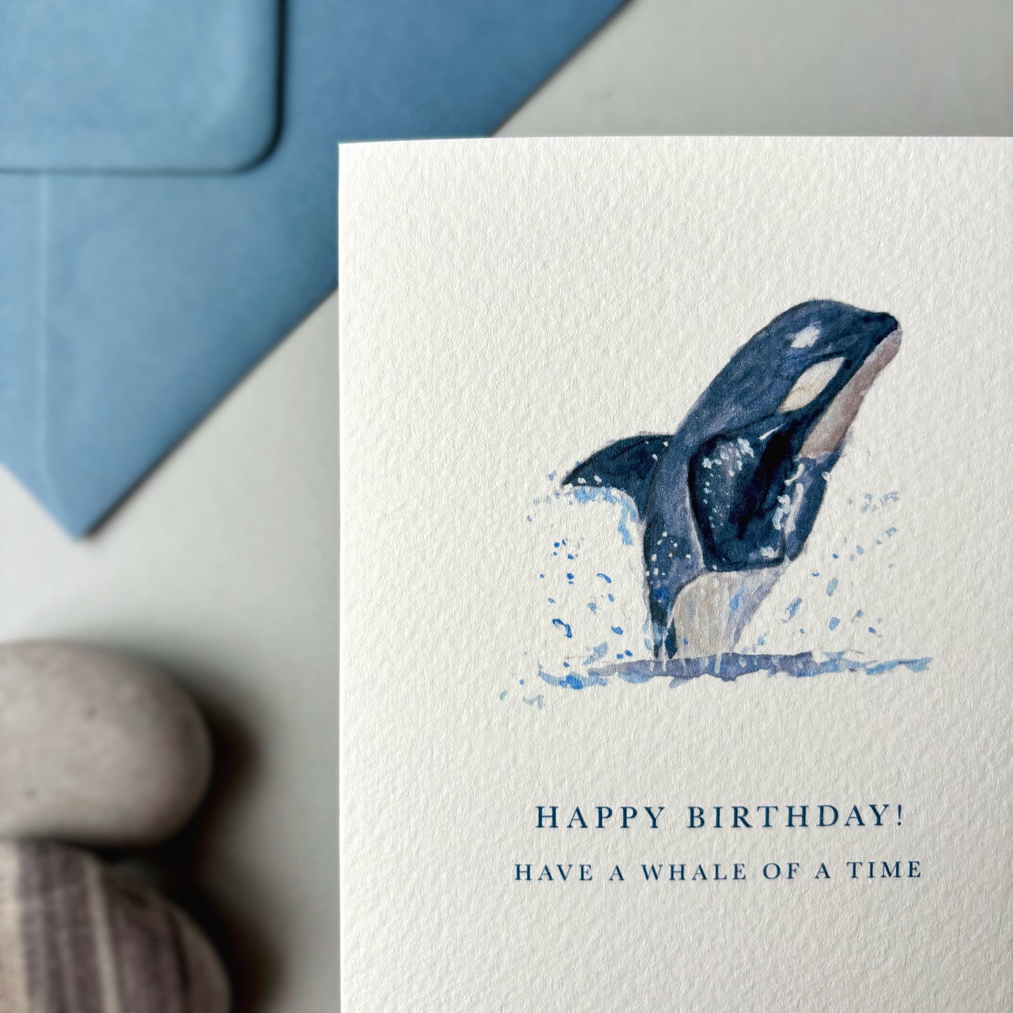Birthday card with whale illustration and blue envelope